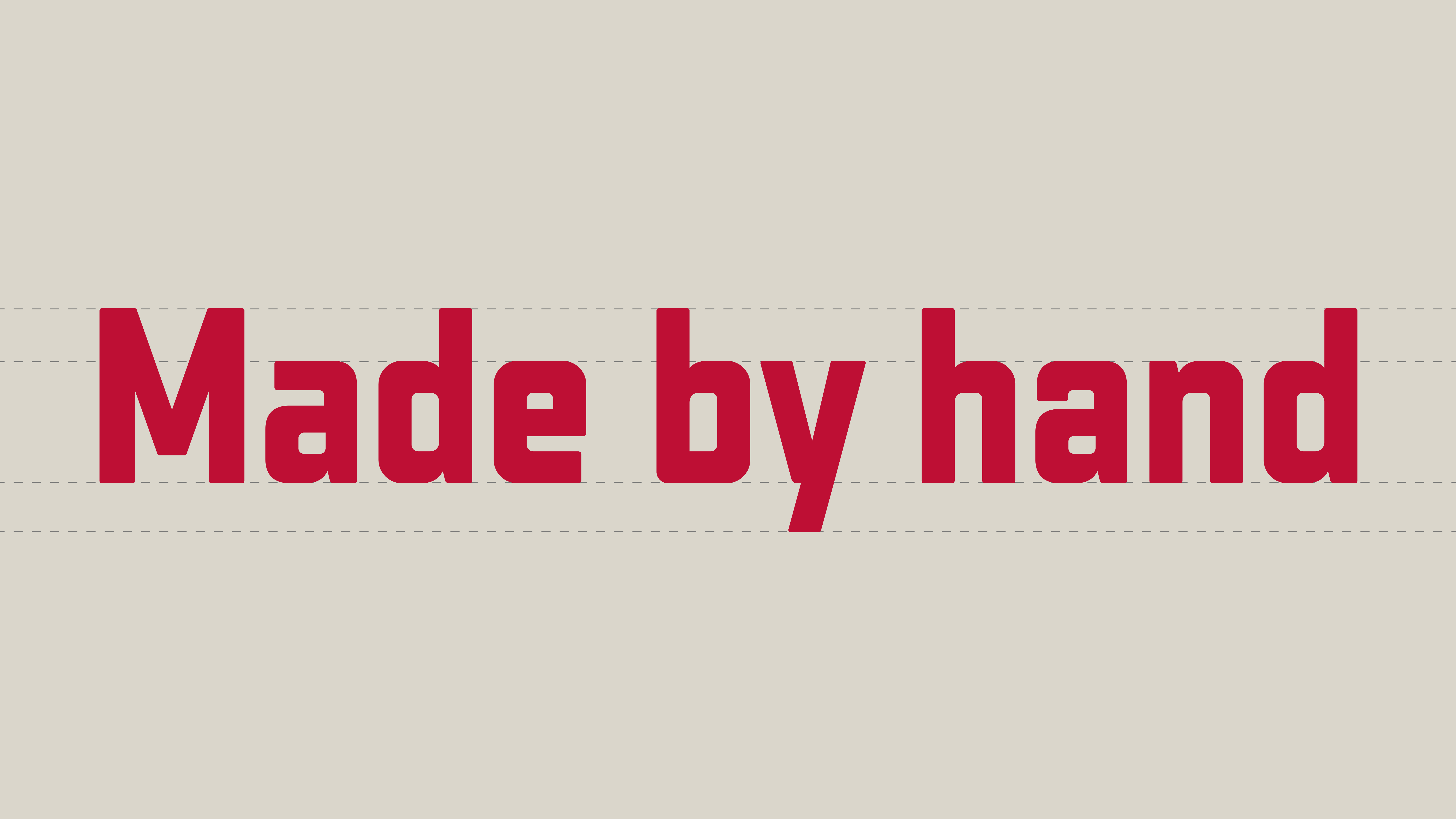 Made by hand written in red text within dotted baselines on a grey background